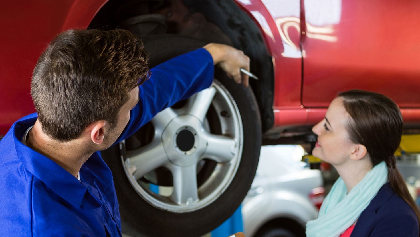 Mechanic showing customer the problem with car